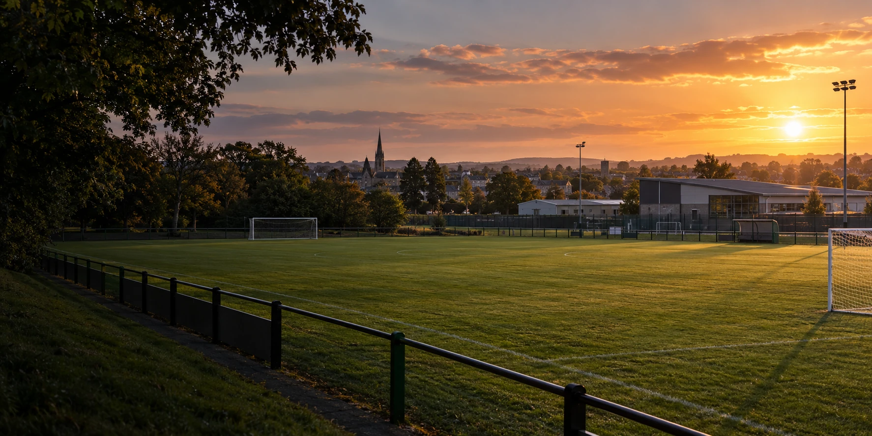 Old Fort Celtic crest over a Portlaoise football pitch at sunset