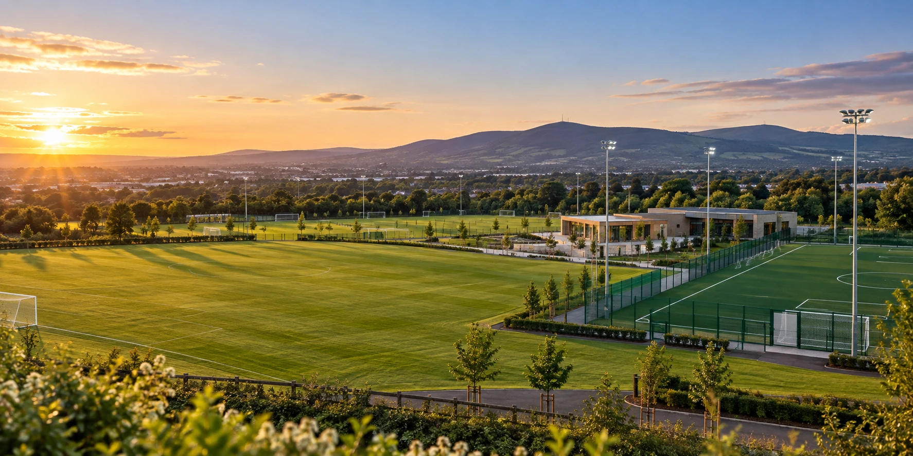 Shamrock Rovers crest over the Roadstone academy grounds with Dublin hills beyond