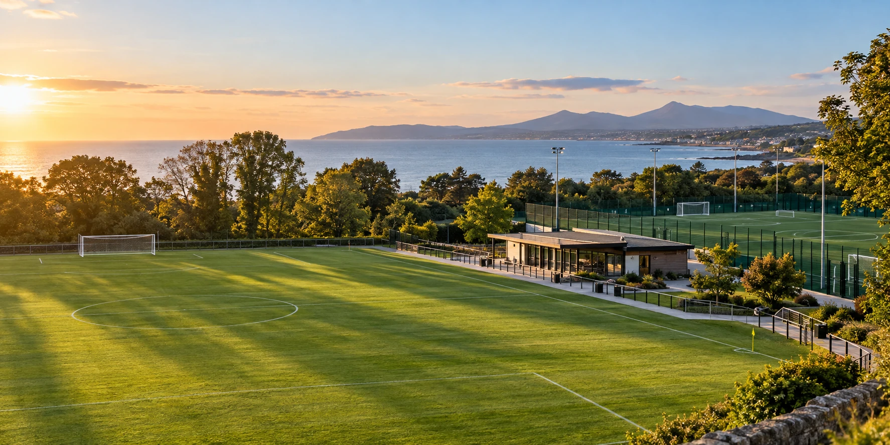 Shankill FC crest over Shanganagh Park football pitches with the Dublin coast beyond